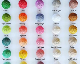 May include: A color palette chart featuring fifty spherical cotton ball lights arranged in five columns. Each ball is labeled with its specific color name, including shades like khaki, amaranth, blackberry, black, chocolate, green, coral, and azure.