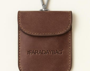 May include: A brown leather Faraday bag with a silver-colored clasp. The bag has a flap closure and stitched edges. The text "FARADAYBAG" is embossed on the front.