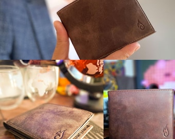 May include: A brown leather bifold wallet featuring a smooth, matte texture and a small, embossed flame-like logo in the bottom right corner. The wallet is shown from multiple angles, highlighting its rectangular shape and stitched edges.