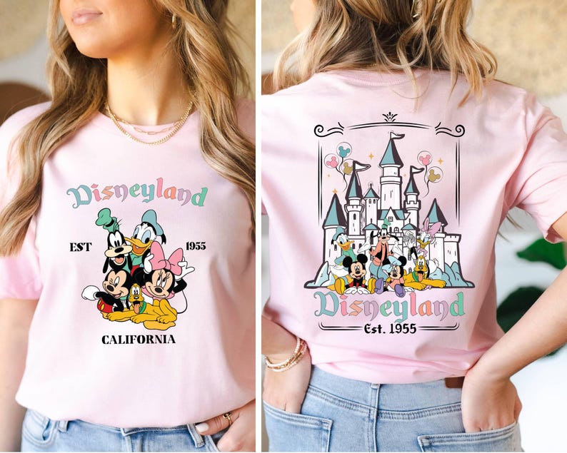 May include: Pink t-shirt with a graphic of Mickey Mouse, Donald Duck, Goofy, Pluto, and Minnie Mouse in front of the Disneyland castle. The text "Disneyland Est. 1955 California" is printed on the shirt.