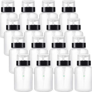 Peut inclure: Un ensemble de 12 flacons en plastique transparent avec des pompes noires. Les flacons sont vides et prêts à être remplis de liquides.