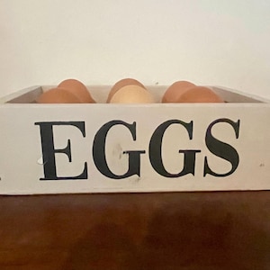 May include: A rustic wooden sign with the text "Welcome to our home" in a handwritten style. The sign features a distressed finish and a simple, inviting design, perfect for entryway decor.