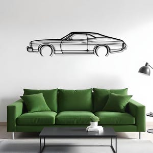 May include: Black metal wall art depicting a classic car silhouette. The artwork features a detailed outline of the car's body, including the roof, windows, and wheels. The car is mounted on a white wall above a green sofa.