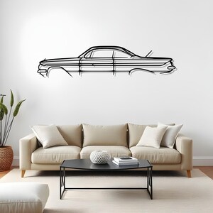 Könnte beinhalten: Schwarze Metall-Wandkunst, die eine Silhouette eines klassischen Autos darstellt. Das Kunstwerk hat ein minimalistisches Design und ist an einer weißen Wand über einem beigen Sofa angebracht. Der Umriss des Autos ist detailliert und zeigt seine ikonische Form.
