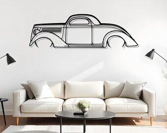 May include: Black metal wall art depicting a classic car silhouette. The artwork features detailed lines outlining the car's body, wheels, and front grill. The car is mounted on a white wall above a white sofa and black coffee table.