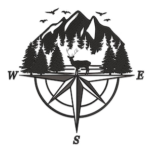 May include: Black and white embroidered design featuring a mountain range, pine trees, a deer, and birds. The design is set within a compass rose, with the letters "W", "E", and "S" indicating directions.