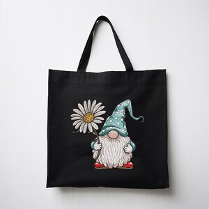 May include: Black tote bag with a white daisy and a gnome holding the flower. The gnome is wearing a blue hat with white polka dots and red shoes.