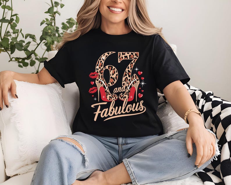 May include: Black t-shirt with a leopard print number 67 and the words "and fabulous" in gold lettering. The number 67 is decorated with red high heels.