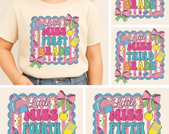 May include: A beige t-shirt featuring a colorful graphic design with the text "Little Miss First Grade". The design includes a backpack, apple, notebook, and bow. Additional designs show "Second Grade", "Third Grade", "Fourth Grade", and "Fifth Grade".
