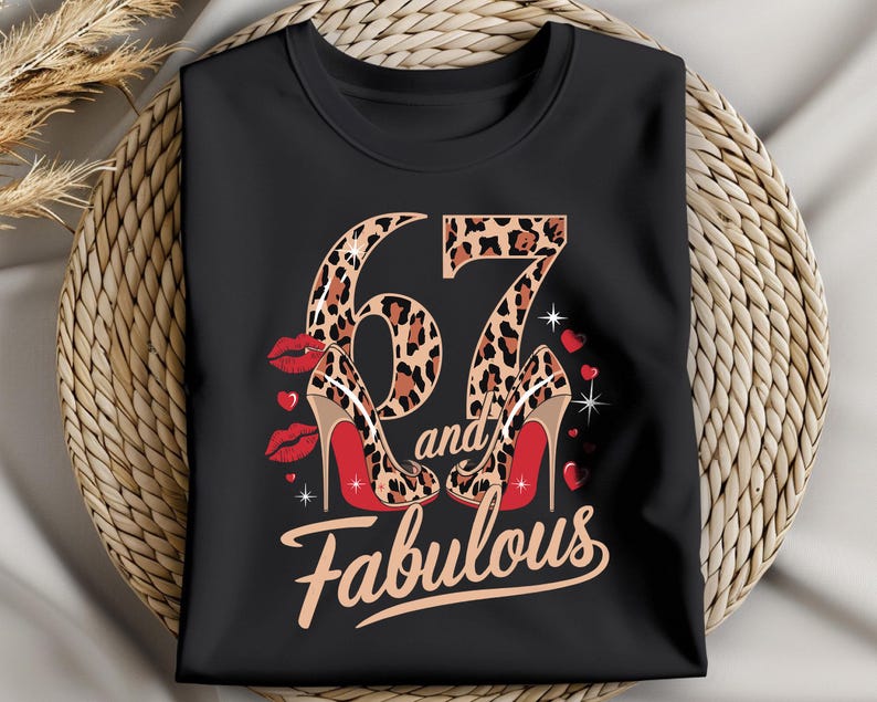 May include: Black t-shirt with a leopard print number 67 and the words "and fabulous" in white. The number 67 is surrounded by red lips and red high heels.