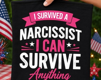 May include: A black fabric item featuring the white and pink text I SURVIVED A NARCISSIST I CAN SURVIVE Anything. The design includes pink banners, white stars, and decorative lines, with the text arranged in a bold, centered graphic layout.