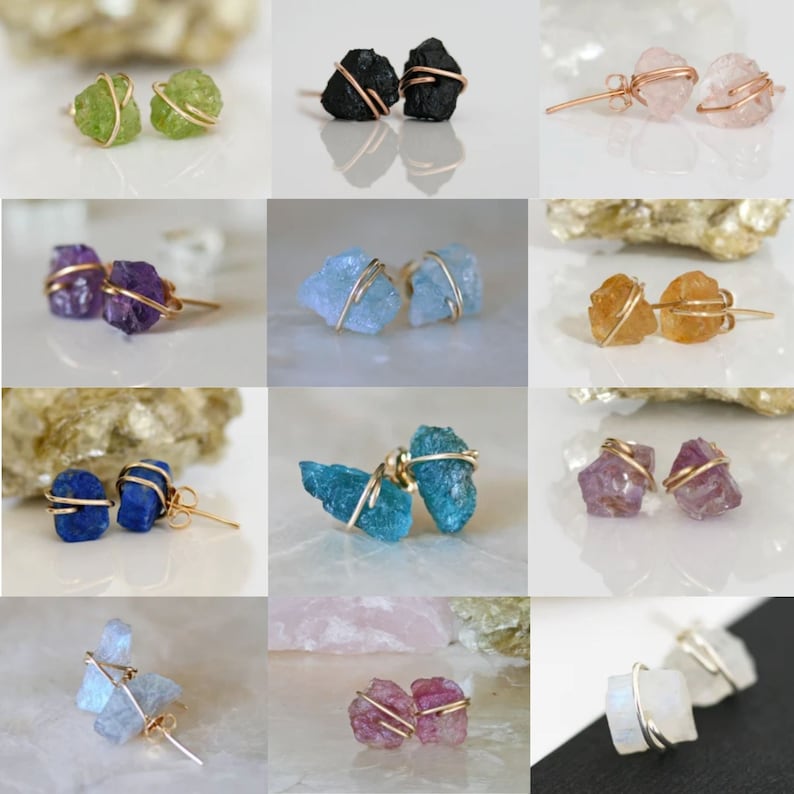 May include: A set of 10 pairs of earrings featuring different colored natural stone crystals wrapped in gold wire. The stones include amethyst, aquamarine, blue apatite, black obsidian, carnelian, green aventurine, pink rose quartz, ruby, clear quartz, and lapis lazuli.