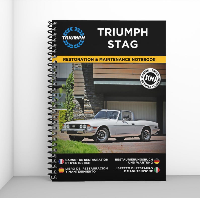 May include: A spiral-bound notebook titled "TRIUMPH STAG RESTORATION & MAINTENANCE NOTEBOOK." The cover features a white Triumph Stag car and the Triumph logo. The notebook includes 100 pages and text in multiple languages.