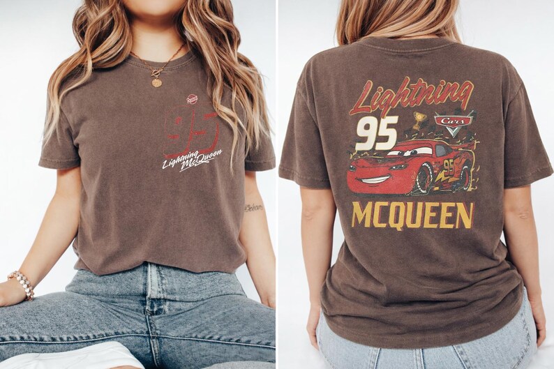 May include: A brown short-sleeve t-shirt featuring a small Lightning McQueen graphic on the front left chest and a large graphic on the back displaying a red race car, the number 95, a trophy, the Cars logo, and the text Lightning McQueen.