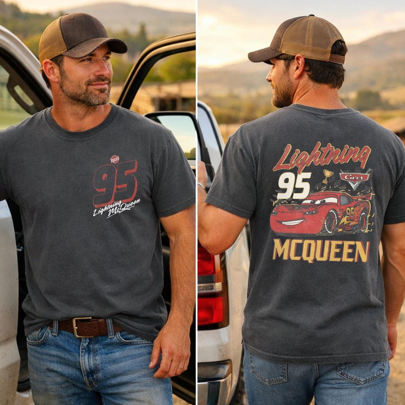 May include: A charcoal grey short-sleeve t-shirt featuring a small red and white 95 Lightning McQueen graphic on the front left chest and a large graphic on the back showing the red race car with the text Lightning 95 MCQUEEN and a trophy.