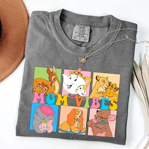 May include: Gray t-shirt with a colorful graphic of Disney characters and the text "MOM VIBES".