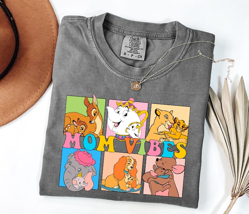 May include: Gray t-shirt with a colorful graphic of Disney characters and the text "MOM VIBES".
