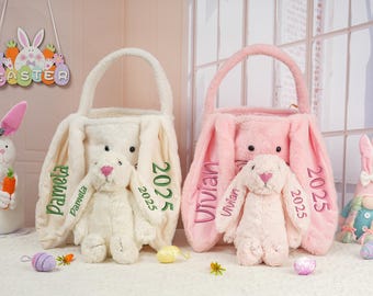 May include: Two plush bunny-shaped Easter baskets with bunny plushies inside. The white basket has "Pamela 2025" embroidered on it, and the pink basket has "Vivian 2025" embroidered on it.