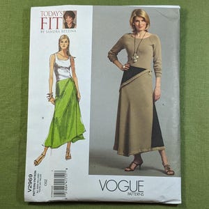 May include: Vogue Patterns sewing pattern featuring a woman in a long-sleeved dress with a black panel and a woman in a tank top and green skirt. The pattern is titled "Today's Fit" by Sandra Betzina.