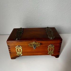 Vintage cedar jewelry box with brass detail.