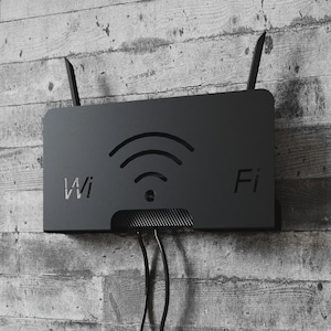 May include: A black Wi-Fi router mounted on a gray, textured wall. The router has two antennas and a Wi-Fi symbol. The word "Wi" is on the left, and "Fi" is on the right. Black cables extend from the bottom.