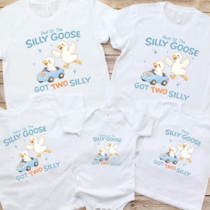 May include: White family matching t-shirts and a onesie with a cartoon goose design. The shirts read "Dad Of The Silly Goose Got Two Silly", "Mom Of The Silly Goose Got Two Silly", "Sister Of The Silly Goose Got Two Silly", and "This Silly Goose Got Two Silly".