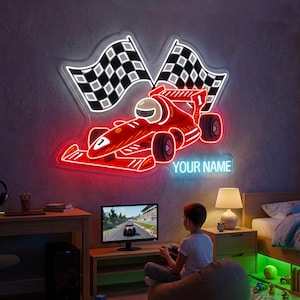 May include: A red neon sign shaped like a race car with two checkered flags. The sign includes the text "YOUR NAME" in blue neon. A child is sitting in front of a TV playing a racing game.