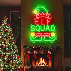May include: A festive Christmas scene featuring a decorated tree with ornaments and lights, a fireplace with stockings, and a neon sign that reads "ELF SQUAD" in red and green. The fireplace has a roaring fire.