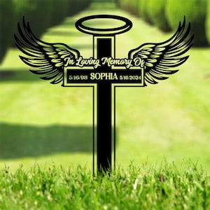 May include: Black metal cross with angel wings and a halo, with the text "In Loving Memory Of" and the name "SOPHIA" and dates "5/16/98" and "5/16/2024".