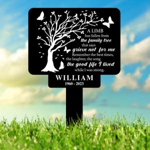 May include: Black metal garden memorial sign with a tree silhouette and the text "A limb has fallen from the family tree that says grieve not for me. Remember the best times, the laughter, the song the good life I lived while I was strong. WILLIAM 1960-2023"