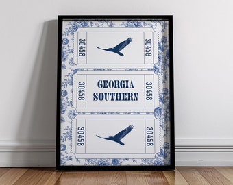 May include: A framed print with a blue and white design featuring a repeating pattern of tickets with the text "Georgia Southern" and a silhouette of a bird. The tickets have the number 30458 printed on them.
