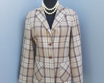 May include: A brown and white plaid blazer with a single-breasted closure and two front pockets. The blazer is on a mannequin wearing a pearl necklace.