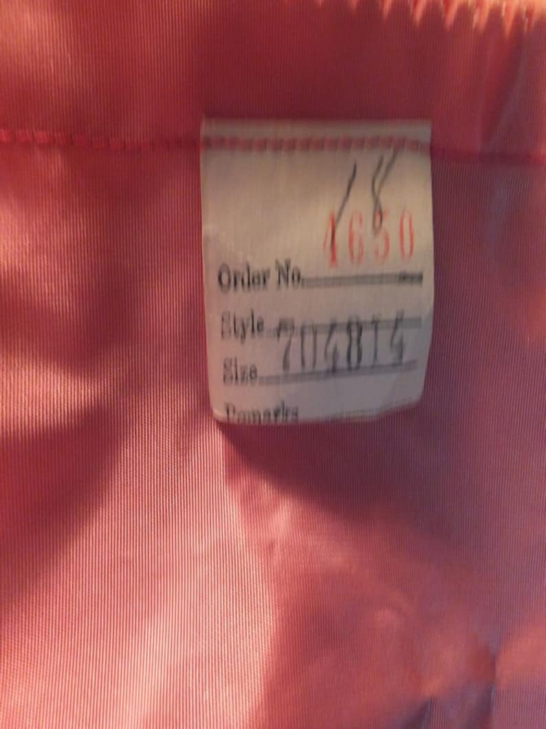 May include: A white tag with black text that reads "Order No. ____ Style ____ Size ____ Remarks" with the numbers 4650 and 704814 filled in.