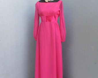 May include: A long, hot pink dress with long sleeves and a satin sash. The dress has a square neckline and a button closure at the front.