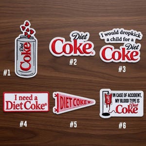 May include: A collection of six Diet Coke patches with various designs. One patch shows a Diet Coke can with hearts, another reads "Diet Coke," and a third says "I would dropkick a child for a Diet Coke."