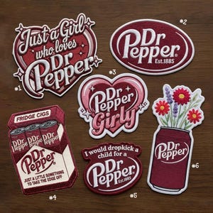 May include: Six embroidered patches featuring Dr Pepper branding. Patch 1 says Just a Girl who loves Dr Pepper. Patch 2 is an oval Dr Pepper logo. Patch 3 is a heart shape with Dr Pepper Girly. Patch 4 is a pack of Fridge Cigs. Patch 5 says I would dropkick a child for a Dr Pepper. Patch 6 is a soda can with flowers.