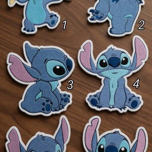 May include: Set of six embroidered patches featuring the character Stitch from Lilo & Stitch. Each patch showcases Stitch in various poses, with blue and pink color schemes. One patch holds ice cream, another plays a guitar.