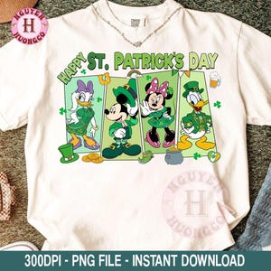 May include: White t-shirt featuring a colorful graphic for St. Patrick's Day. The design includes cartoon characters Mickey Mouse, Minnie Mouse, Donald Duck, and Daisy Duck in green outfits. The words "Happy St. Patrick's Day" are printed above the characters.