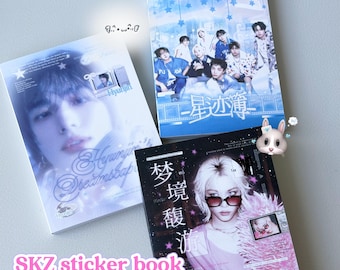 May include: Three rectangular sticker books featuring Stray Kids members. One book shows Hyunjin with the text 'Hyunjin Dreamscape', another displays the group with blue tones and Chinese characters, and the third features Felix in pink with Chinese text.
