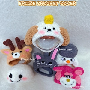 May include: A collection of handmade crochet bottle covers in various animal designs, including a dog, deer, bunny, penguin, and monkey. The covers are in shades of white, brown, gray, and pink, with the text "BRIZE CROCHET COVER".