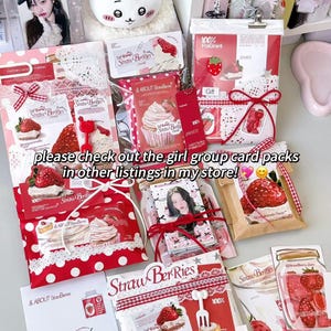 May include: A selection of strawberry-themed gift packs and cards, with images of strawberries, cupcakes, and the text "Straw Berries." The packs are in red and white with ribbons and lace. The text "please check out the girl group card packs in other listings in my store!" is also visible.