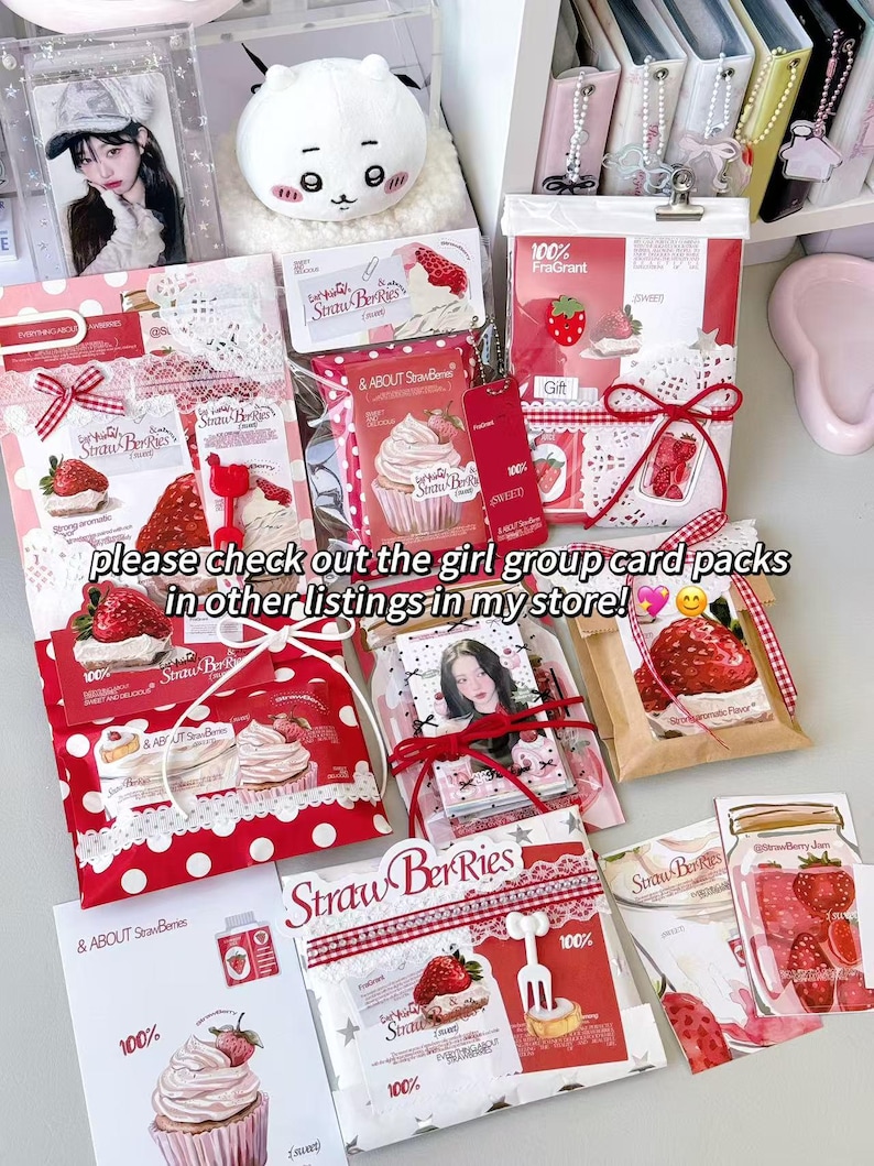 May include: A selection of strawberry-themed gift packs and cards, with images of strawberries, cupcakes, and the text "Straw Berries." The packs are in red and white with ribbons and lace. The text "please check out the girl group card packs in other listings in my store!" is also visible.