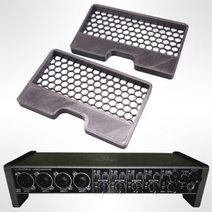 May include: Two black 3D printed protective grilles for a Behringer U-Phoria UMC404HD audio interface. The grilles are designed to fit over the knobs and faders of the interface, protecting them from dust and damage.
