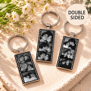 May include: Three rectangular metal keychains featuring black and white film strip photo collages. Each keychain has a silver split ring and displays multiple candid portraits of people. The text DOUBLE SIDED is printed on a circular white background.