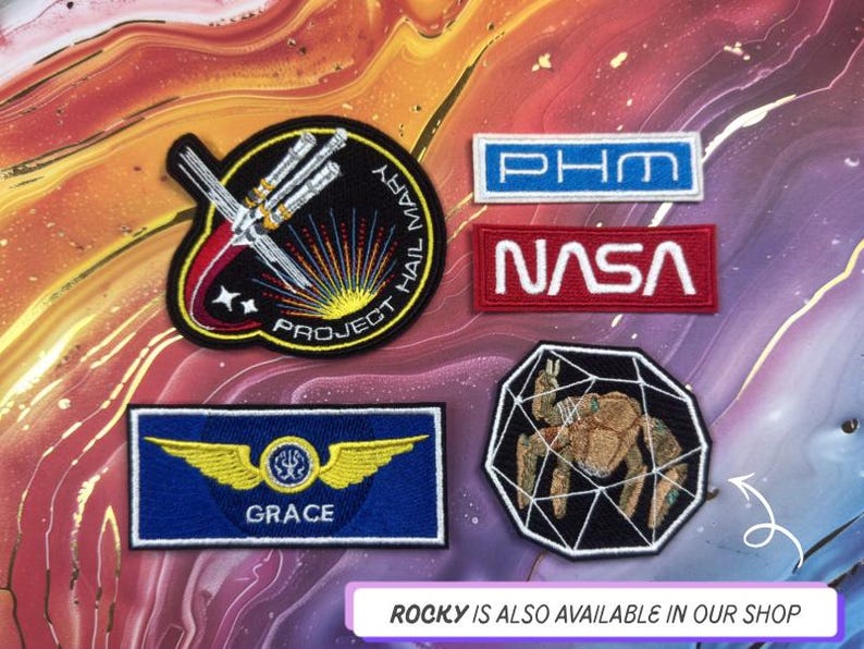 May include: A collection of embroidered patches with space and science themes. Includes a patch with the text "NASA" in white on a red background, and a patch with the text "GRACE" and wings on a blue background.