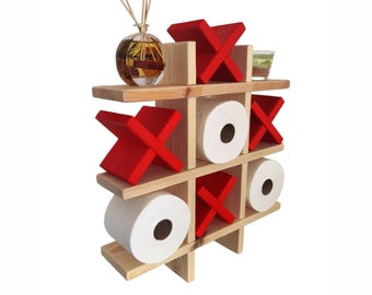 May include: A wooden tic-tac-toe game with red X's and white O's. The game is designed to hold toilet paper rolls.