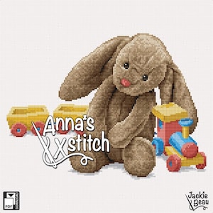 May include: A cross-stitch pattern featuring a brown bunny plush toy with a pink nose and a collection of toy train cars. The text "Anna's Xstitch" is displayed with a needle and thread. The design includes a PDF download icon.