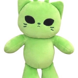 May include: A lime green plush toy resembling a cat-alien hybrid. It features large black oval eyes, small whiskers, and two antennae. The soft toy has a rounded body, arms, and legs, designed for cuddling.