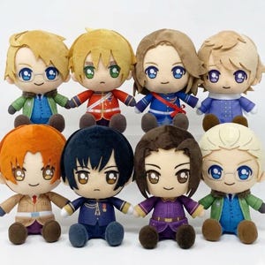 Peut inclure: Une tasse en céramique blanche avec une anse noire et l'inscription "But First, Coffee" en gras noir. La tasse est posée sur un fond flou, suggérant un cadre chaleureux.