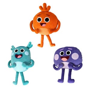 May include: Three plush toys in the shape of cartoon characters. The toys are orange, teal, and purple, each with large eyes, smiling mouths, and small arms and legs. The orange character has a sprout on top.